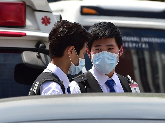South Korean hospital security guards wear masks at the Seoul National University Hospital in Seoul on June 2, 2015. South Korea's health ministry confirmed that two people have died from Middle East Respiratory Syndrome (MERS), the country's first fatalities from the virus. AFP PHOTO / JUNG YEON-JE