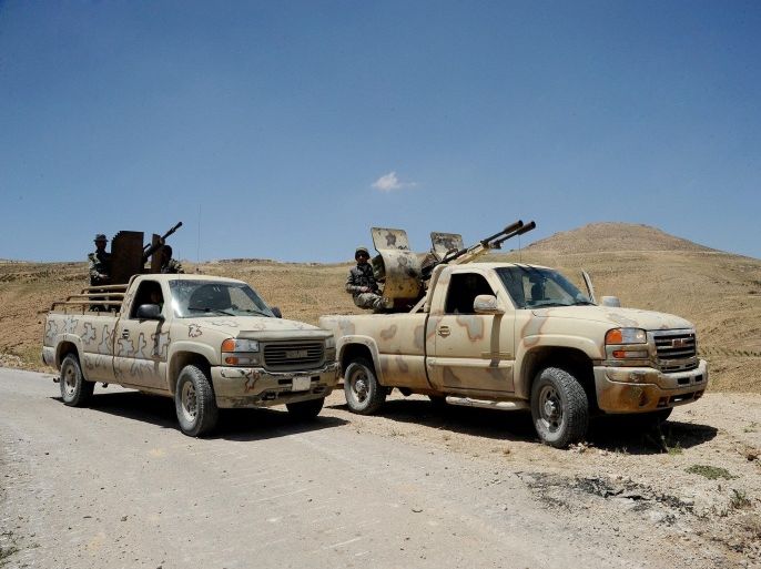 A handout picture made available by the official Syrian Arab News Agency (SANA) on 06 June 2015 is described as showing Syrian army soldiers and Hezbollah members on armed pick-up trucks in the Flita height in the Qalamoun mountains at the Syrian-Lebanese border, on 06 June 2015. The Syrian army and Hezbollah fighters reportedly made advances on 05 June against Islamist rebels in the region of Qalmun near the border with Lebanon, activists and the Shiite movement said. They regained control of Zahweh Plains, a stronghold of Islamist militants led by the al-Qaeda-linked al-Nusra Front on the outskirts of the Lebanese town of Arsal. The Syrian Observatory for Human Rights monitoring group reported territorial gains by the Syrian army and Hezbollah in Qalmun, while pro-Syrian al-Mayadeen TV showed footage of deserted posts which it said belonged to al-Nusra in Zahweh Plains.