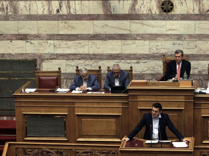 Greek Prime Minister Alexis Tsipras (R) speaks at a debate on the referendum in the plenary session at the Greek Parliament in Athens, Greece, early 28 June 2015. Tsipras called for a referendum on the Greek debt deal on 05 July, during a televised speech late night on 27 June on Greek state TV. Eurozone finance ministers on 27 June rejected a request to extend the European part of Greece's bailout programme beyond 30 June, casting serious doubts on the Mediterranean nation's permanence in the European common currency.