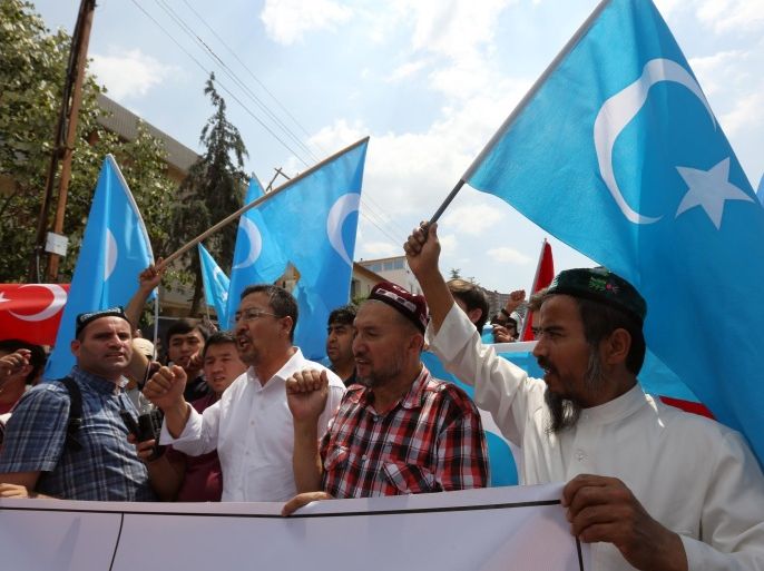 A group of Uighur protesters demonstrate outside the Thai embassy in Ankara, Turkey, Thursday, June 9. 2015. Thailand sent back to China more than 100 ethnic Uighur refugees on Thursday, drawing harsh criticism from the U.N. refugee agency and human rights groups over concerns that they face persecution by the Chinese government. Protesters in Turkey, which accepted an earlier batch of Uighur refugees from Thailand, ransacked the Thai Consulate in Istanbul overnight.(AP Photo/Burhan Ozbilici)