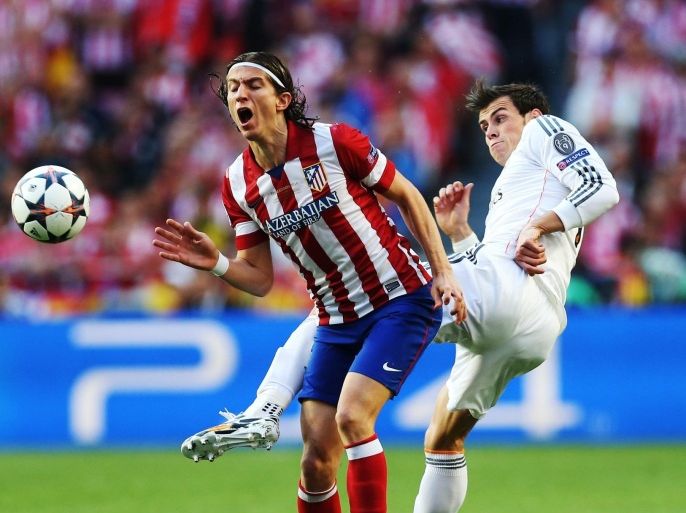 LISBON, PORTUGAL - MAY 24: Filipe Luis of Atletico Madrid vies with Gareth Bale of Real Madrid during the UEFA Champions League Final match between Real Madrid and Athletico Madrid at The Estadio da Luz on May 24, 2014 in Lisbon, Portugal.