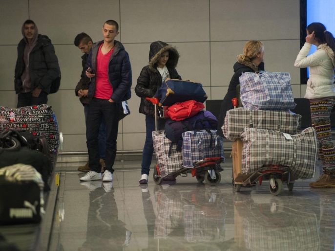 Kosovo immigrants wait for their luggages upon their arrival at Pristina's Airport on February 24, 2015, after being expelled from Hungary. A first group of around 80 Kosovo immigrants arrived in Pristina after being expelled from Budapest. The past few weeks has since an influx of impoverished Kosovo Albanians into the EU. The migrants, who require a visa to enter the passport-free Schengen area, generally first cross into northern Serbia and then pay smugglers hefty amounts to spirit them illegally across the border into EU member Hungary. AFP PHOTO / ARMEND NIMANI