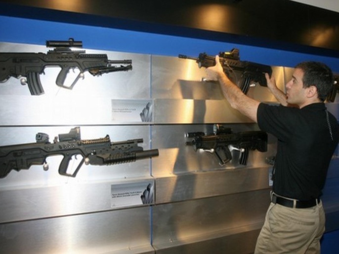 An Israeli armament industry worker adjusts a Tauor Assault Rifle Tars 5.56 mm at the Israel defence stall at the international DefExpo 2008 defence fair, in New Delhi on February 16, 2008. India kicked off South Asia's largest defence fair, with hundreds of global weapons firms offering their latest hardware to the country's technology-hungry military. About 450 weapons companies from 30 countries are present at the four-day "DefExpo" in New Delhi, with several big-ticket announcements expected.