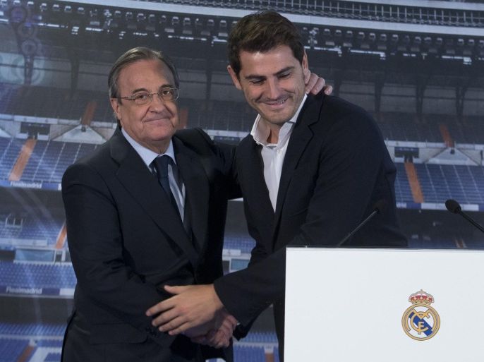 Goalkeeper Iker Casillas, right, smiles as he embraces Real Madrid’s President Florentino Perez before a press conference at the Santiago Bernabeu stadium in Madrid, Spain, Monday July 13, 2015. Casillas appeared with the club’s president a day after he gave an emotional press conference alone putting an end to his 25 years as a Real Madrid goalkeeper. Casillas will now play for FC. Porto. (AP Photo/Paul White)