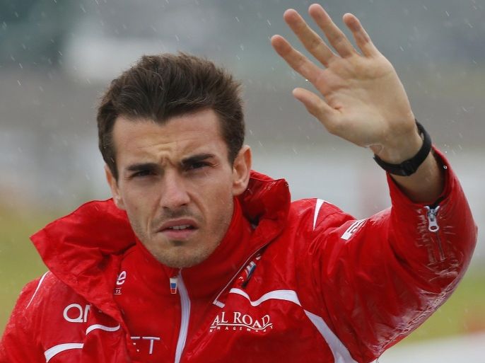 Marussia driver Jules Bianchi of France waves during drivers' parade before the Japanese Formula One Grand Prix at the Suzuka Circuit in Suzuka, central Japan, Sunday, Oct. 5, 2014. Bianchi has been taken to hospital and is unconscious following a crash during the Japanese Grand Prix. The race was red-flagged with nine laps to go after Bianchi went off at Turn 7, where Sauber's Adrian Sutil had crashed earlier. (AP Photo/Shizuo Kambayashi)