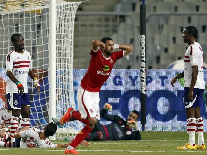 El Zamalek players react after Al-Ahly's Moamen Zakaria (C) scored a goal during their Egyptian Premier League derby soccer match at Borg El Arab "Army" Stadium, west of the Mediterranean city of Alexandria, July 21, 2015. The match was played without spectators due to security reasons. REUTERS/Amr Abdallah Dalsh