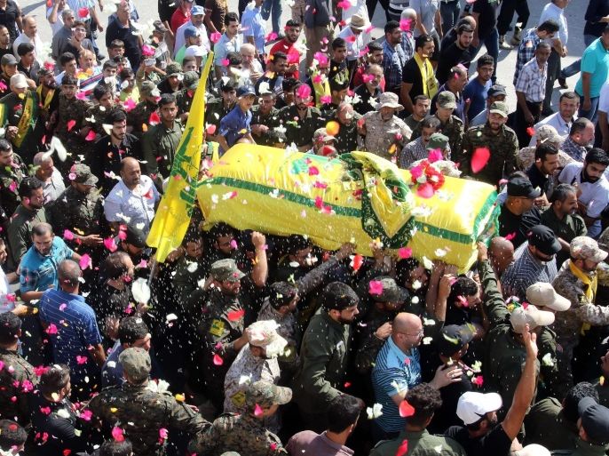 Members of Lebanon's Shiite movement Hezbollah carry the coffin of Mohammed Kujk, who died during clashes in Syria's Zabadani area, during his funeral in the village of Kawthariet al-Seyyad, south of the southern Lebanese city of Sidon on July 26, 2015. AFP PHOTO / MAHMOUD ZAYYAT