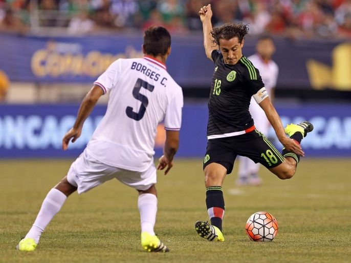 Mexico's Andres Guardado (R) takes a shot defended by Costa Rica's Celso Borges during the first half of their CONCACAF Gold Cup quarter final match at MetLife Stadium in East Rutherford, New Jersey, USA, 19 July 2015. The CONCACAF finals will be played on 26 July.