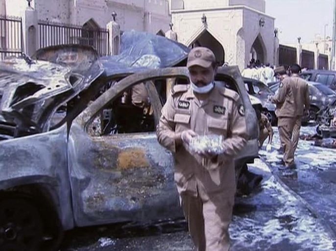 FILE - In this May 29, 2015 still file image taken from video provided by Saudi TV, burnt out cars are seen as investigators collect evidence, in the aftermath of a suicide bomb outside the Imam Hussein mosque in the port city of Dammam, Saudi Arabia. On Saturday, July 18, 2015, the Saudi Interior Ministry announced that it broke up planned Islamic State attacks in the kingdom, and arrested over 400 people and accused those arrested over the "past few weeks" of conducting several attacks in the kingdom. (Saudi Television via AP, File) SAUDI ARABIA OUT