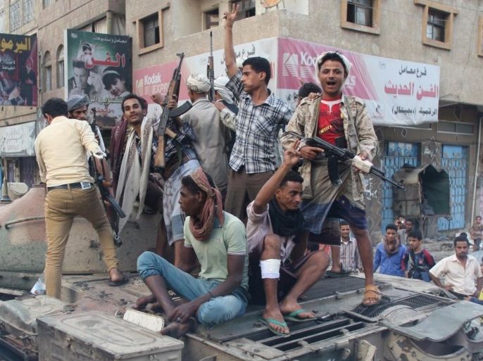 Militants loyal to Yemen's exiled government ride atop a tank they seized from Houthi militiamen in the country's central city of Taiz August 17, 2015. Militia forces loyal to Yemen's exiled government fought their way deep into the central city of Taiz on Sunday, local officials said, largely pushing out Houthi militiamen from the country's third largest city. REUTERS/Stringer
