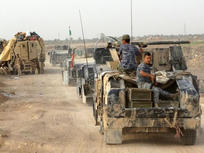 Iraqi security forces ride military vehicles on the outskirts of Ramadi August 6, 2015. After only modest gains in the first few weeks of their drive to retake Anbar province, Iraqi government forces have given up hopes of swift advances against Islamic State militants. REUTERS/Stringer NO ARCHIVES