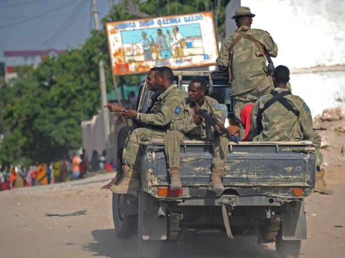 Somali soldiers patrol in a pickup truck near the site where Al Shebab militants carried out a suicide attack against a military intelligence base in Mogadishu on June 21, 2015. Shebab militants launched a major suicide raid on June 21 against a military intelligence base in the capital Mogadishu, setting off a car bomb before storming inside, security officials said. Somalia's interior ministry said the three attackers were all killed in the raid, and that Somali security forces who fought them suffered no casualties. AFP PHOTO / MOHAMED ABDIWAHAB