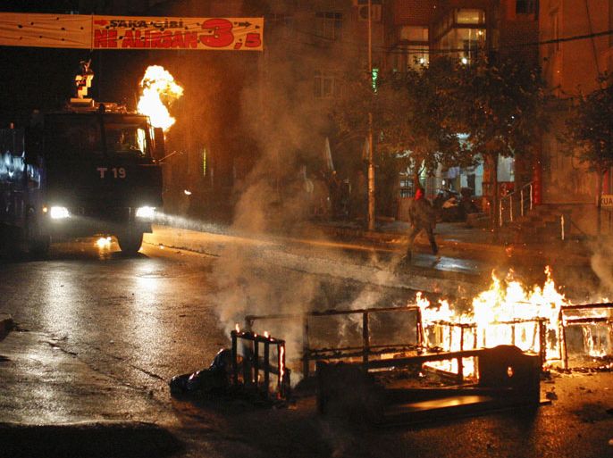 A left-wing protester hurls a petrol bomb at a Turkish police water canon during minor clashes between police and people protesting Turkey's operations against Kurdish militants in Istanbul, Wednesday, Aug. 19, 2015. There has been a sharp escalation of violence between Turkey's security forces and the Kurdistan Workers' Party, or PKK, along with the collapse of a two-year peace process with the rebels. Dozens of people, mostly Turkish soldiers, have died since July in the renewed violence. (AP Photo/Cagdas Erdogan) TURKEY OUT