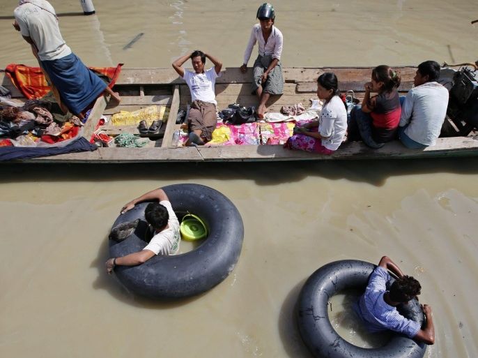 Residents in a boat passing along a flooded road in Kale township of Sagaing Region, Myanmar, 02 August 2015. Myanmar president declared four regions (Sagaing, Magway Regions and Rakhine, Chin States) as disaster zones on 31 July 2015. Heavy monsoon rains caused floods around Myanmar with dozens deaths being reported as thousands are fleeing their homes in several regions across the country. In Myanmar monsoon starts at the beginning of June and ends in September.