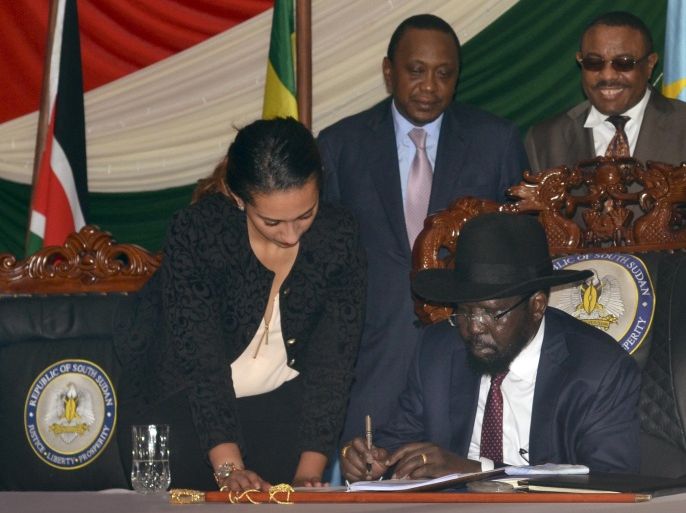 South Sudan President Salva Kiir, seated, signs a peace deal, as Kenya’s President Uhuru Kenyatta, center, and Ethiopia’s Prime Minister Hailemariam Desalegn, right, witness the signing while standing behind, in the capital Juba, South Sudan Wednesday, Aug. 26, 2015. Kiir on Wednesday signed a peace deal with rebels, more than 20 months after the start of fighting between the army and rebels led by his former deputy Riek Machar. (AP Photo/Jason Patinkin)