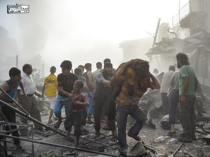 In this photo provided by the Syrian anti-government activist group Ariha Today, which has been authenticated based on its contents and other AP reporting, Syrian citizens help out an injured boy as another carry a man after a government forces warplane crashed in the center of Ariha town in the northwestern province of Idlib, Syria, Monday, Aug. 3, 2015. Government air raids and the subsequent crash by the Syrian warplane that slammed into the residential area there killed dozens of people, activists said. (Ariha Today via AP)