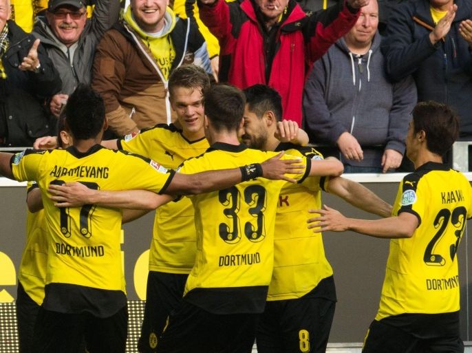 Dortmund players celebrate the 1-0 goal during the German Bundesliga soccer match between Borussia Dortmund and Bayer Leverkusen at Signal-Iduna-Park in Dortmund, Germany, 20 September 2015. (EMBARGO CONDITIONS - ATTENTION: Due to the accreditation guidelines, the DFL only permits the publication and utilisation of up to 15 pictures per match on the internet and in online media during the match.)