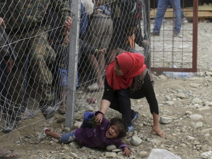 Police try to stop migrants going under a fence to board a train at a station near Gevgelija, Macedonia, September 7, 2015. Several thousand migrants in Macedonia boarded trains on Sunday to travel north after spending a night in a provisional camp. Macedonia has organised trains twice a day to the north border where migrants cross into Serbia to make their way to Hungary. Since June, Macedonian authorities have said that more than 60,000 migrants have entered the country, and around 1,500 entered just in one day, mainly refugees from Syria. REUTERS/Stoyan Nenov TPX IMAGES OF THE DAY