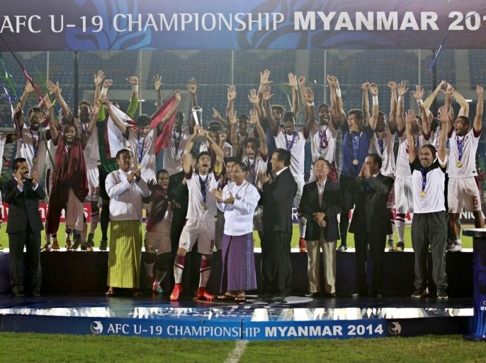 Qatar soccer team members celebrate with trophy after wining AFC U-19 Championship final against North Korea in Yangon, Myanmar, 23 October 2014. Qatar became Asian Football Confederation under-19 champion after wining with the result 1-0.