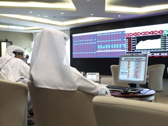 Traders watch share prices on an electronic display at the Doha Stock Exchange in Doha, Qatar June 3, 2015. Qatar's stock index hit a six-week low in early trade on Wednesday after Sepp Blatter unexpectedly resigned as president of world soccer body FIFA. The Doha benchmark dropped as much as 3.2 percent shortly after the market opened, before cutting its losses to 1.6 percent. REUTERS/Naseem Zeitoon
