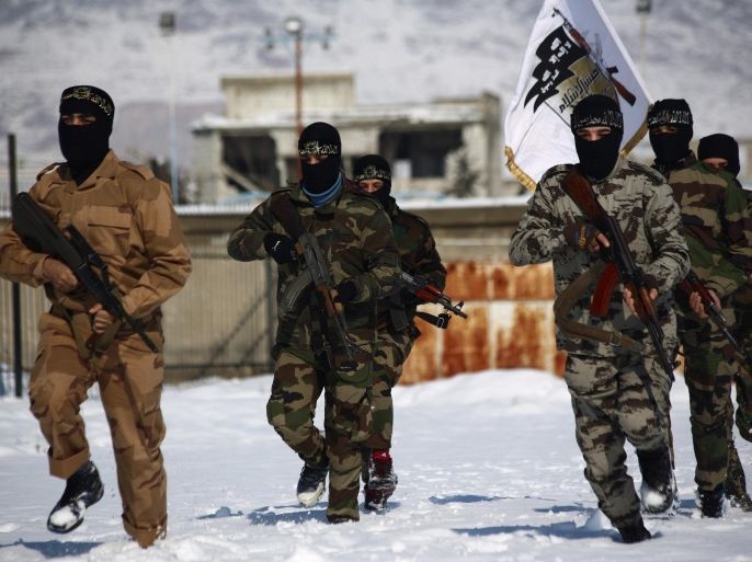 Rebel fighters with the Jaish al-Islam (Army of Islam) run during a training session in Eastern al-Ghouta, a rebel-held region outside the capital Damascus on January 11, 2015. Syria's conflict began as a pro-democracy revolt that later morphed into a brutal civil war after President Bashar al-Assad's regime unleashed a brutal crackdown against dissent. AFP PHOTO/ ABD DOUMANY