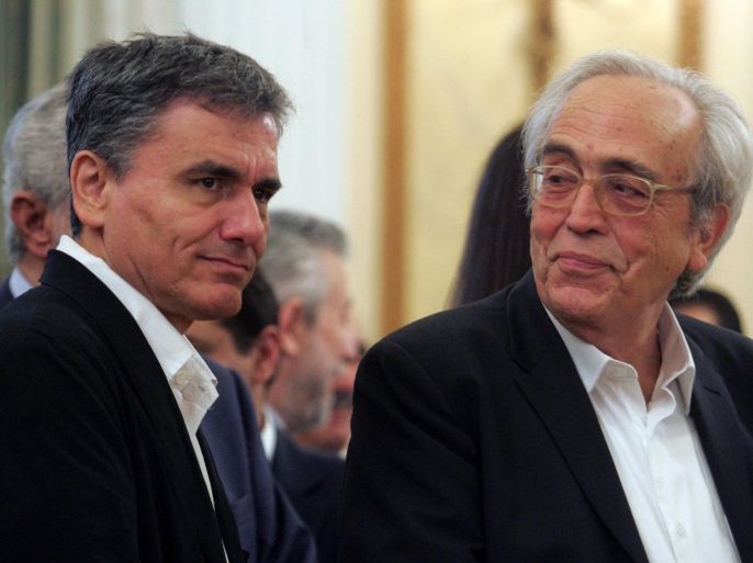 Greek Culture and Sports Ministry Aristidis Baltas (R) looks Finance Minister Euclid Tsakalotos (L) during the swearing-in ceremony of the new government, at the Presidential Mansion in Athens, Greece, 23 September 2015.
