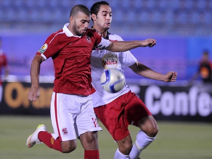 SUEZ, EGYPT - JULY 25: Emad Moteb of Al-Ahly (L) in action against Ammar Al Gamal of Etoile Sportive du Sahel (R) during the Confederation of African Football (CAF) Confederation Cup match between Etoile Sportive du Sahel and Al-Ahly at Suez Stadium in Suez, Egypt on July 25, 2015.
