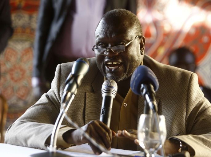 South Sudan's former Vice President and South Sudanese rebel leader Riek Machar speaks with displaced Sudanese people who fled South Sudan due to conflict during a meeting in the capital Khartoum to discuss their options following the recently signed peace agreement to end the war in South Sudan on September 18, 2015. South Sudan's conflict erupted in December 2013, when President Salva Kiir accused his former deputy Riek Machar of plotting a coup, setting off a cycle of violence that split the country along ethnic lines. AFP PHOTO / ASHRAF SHAZLY