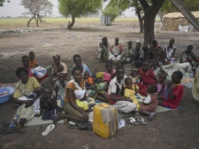 In the photo of March 4, 2015, mothers sit with their children waiting to receive malnutrition assistance in the Nile west bank village of Lul South Sudan's Upper Nile state. Thousands of civilians in South Sudan's Upper Nile state face starvation after the government blocked aid groups from using the Nile River to deliver relief food, aid agencies said Friday, July 31, 2015. (AP Photo/Jason Patinkin)