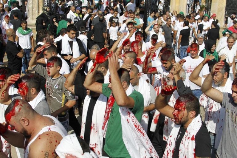 Heavily-bloodied members of the guerrilla Moslem Shi'ite Amal movement beat themselves as they mourn Imam Hussein, one of the grandsons of Prophet Mohammad, during Ashura day in Nabatyeh, south Lebanon, 24 October 2015, to mark the sacred day of Ashura, the holiest Shiite rite which commemorates the killing of Imam Hussein in 680 AD by armies of the Sunni caliph Yazid in Iraq.