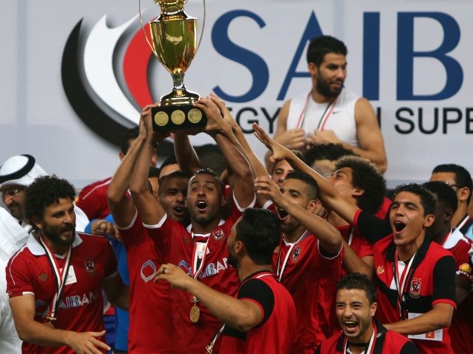 Egypt's Al-Ahly's players celebrate with their trophy after winning the Egypt super cup football match against Egypt's Zamalek on October 15, 2015 at Sheik Hazza Bin Zayed stadium in Al-Ain, UAE. AFP PHOTO / MARWAN NAAMANI