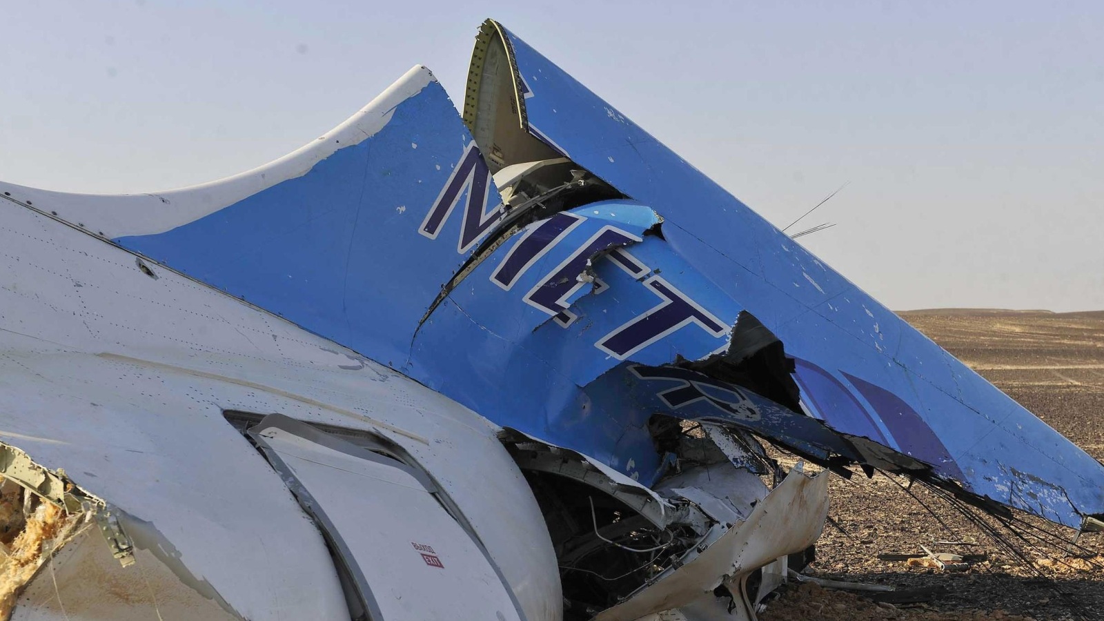 This image released by the Prime Minister's office shows the tail of a Metrojet plane that crashed in Hassana Egypt, Friday, Oct. 31, 2015. The Russian aircraft carrying 224 people, including 17 children, crashed Saturday in a remote mountainous region in the Sinai Peninsula about 20 minutes after taking off from a Red Sea resort popular with Russian tourists, the Egyptian government said. There were no survivors.(Suliman el-Oteify, Egypt Prime Minister's Office via AP)