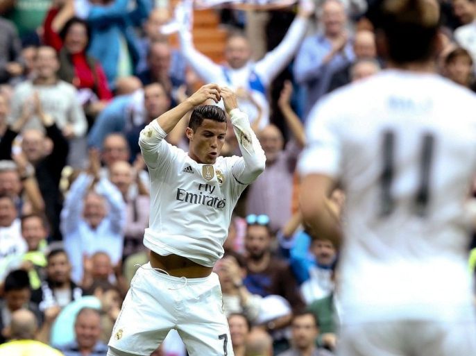 Real Madrid's Portuguese striker Cristiano Ronaldo (L) celebrates after scoring the 2-0 lead against UD Levante during the Spanish Liga Primera Division soccer match played at Santiago Bernabeu stadium, in Madrid, Spain, 17 October 2015.