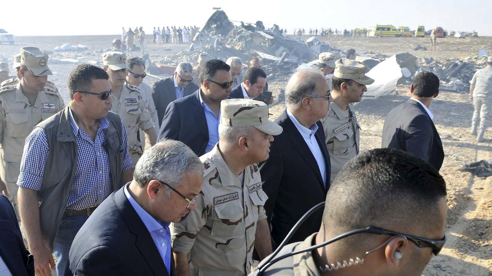 Egypt's Prime Minister Sherif Ismail (C) and Egypt's Defense Minister Sedki Sobhi (2nd L) walk at the site where a Russian airliner crashed in central Sinai near El Arish city, north Egypt, October 31, 2015. The Airbus A321, operated by Russian airline Kogalymavia under the brand name Metrojet, carrying 224 passengers crashed into a mountainous area of Egypt's Sinai peninsula on Saturday shortly after losing radar contact near cruising altitude, killing all aboard. REUTERS/Stringer