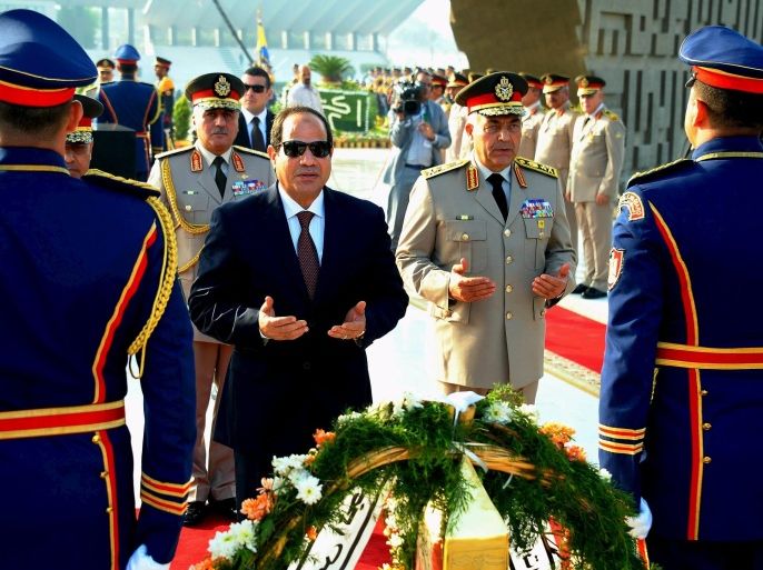 Egyptian President Abdel Fattah al-Sisi (C), Defence Minister Sedki Sobhi and Chief of Staff Mahmoud Hegazy (R) pray for the dead soldiers at the Unknown Soldier Memorial, in commemoration of the 1973 October War, in Cairo, Egypt, October 4, 2015. REUTERS/The Egyptian Presidency/Handout via Reuters. ATTENTION EDITORS - THIS IMAGE WAS PROVIDED BY A THIRD PARTY. REUTERS IS UNABLE TO INDEPENDENTLY VERIFY THE AUTHENTICITY, CONTENT, LOCATION OR DATE OF THIS IMAGE. IT IS DISTRIBUTED EXACTLY AS RECEIVED BY REUTERS, AS A SERVICE TO CLIENTS. FOR EDITORIAL USE ONLY. NOT FOR SALE FOR MARKETING OR ADVERTISING CAMPAIGNS. NO SALES.
