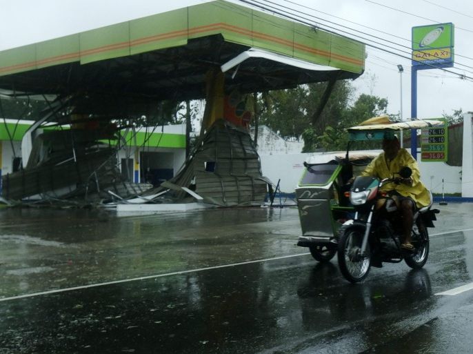 A Filipino on a tricycle rides past a damaged petrol station in the town Munoz, Nueva Ecija province, northern Manila, Philippines, 18 October 2015. Typhoon Koppu slammed into the northern Philippines forcing thousands of people to flee their homes amid heavy rains and strong winds that could last up to three days, the disaster relief agency said. Koppu toppled trees and ripped off rooftops, while nearly 10,000 people evacuated their homes amid warnings of flash floods and storm surges up to three metres.