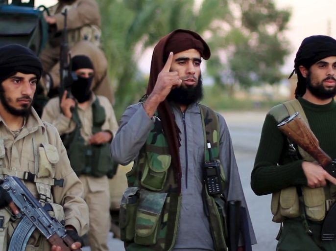 A man (C) identified in the subtitiles as Al Karar the Iraqi, an Islamic State fighter, gestures as he speaks at an undisclosed location in this image taken from undated video footage released by Islamic State. Islamic State warned in the new video on November 16, 2015 that countries taking part in air strikes against Syria would suffer the same fate as France, and threatened to attack in Washington. The video, which appeared on a site used by Islamic State to post its messages, begins with news footage of the aftermath of Friday's Paris shootings in which at least 129 people were killed. REUTERS/Social Media Website via Reuters TVATTENTION EDITORS - THIS PICTURE WAS PROVIDED BY A THIRD PARTY. REUTERS IS UNABLE TO INDEPENDENTLY VERIFY THE AUTHENTICITY, CONTENT, LOCATION OR DATE OF THIS IMAGE. THIS PICTURE IS DISTRIBUTED EXACTLY AS RECEIVED BY REUTERS, AS A SERVICE TO CLIENTS. FOR EDITORIAL USE ONLY. NOT FOR SALE FOR MARKETING OR ADVERTISING CAMPAIGNS. NO RESALES. NO ARCHIVE.