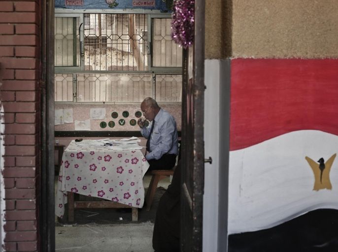 An election judge drinks tea as he waits for voters inside a polling station, during the second phase of parliamentary elections, in Qalyoubiya governorate, north of Cairo Egypt, Sunday, Nov. 22, 2015. Egyptians in nearly half the country, including the capital Cairo, are voting in the second stage of parliamentary elections that will produce the country's first legislature since a chamber dominated by Islamists was dissolved by a court ruling in 2012. (AP Photo/Nariman El-Mofty)