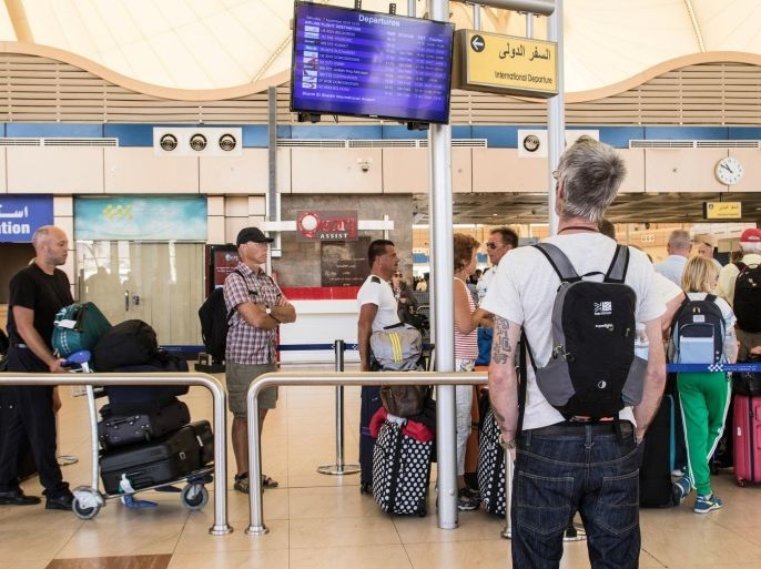 A British tourist looks at the flight information panel at the airport of Sharm el-Sheikh, Egypt, on Saturdya, Nov. 7, 2015. London approved the resumption of British flights to Sinai starting Friday and planned a wave of flights to retrieve its stranded nationals, but it banned passengers from checking luggage on the flights. Instead, any checked-in bags were to be brought later on cargo planes. (AP Photo/Vinciane Jacquet)