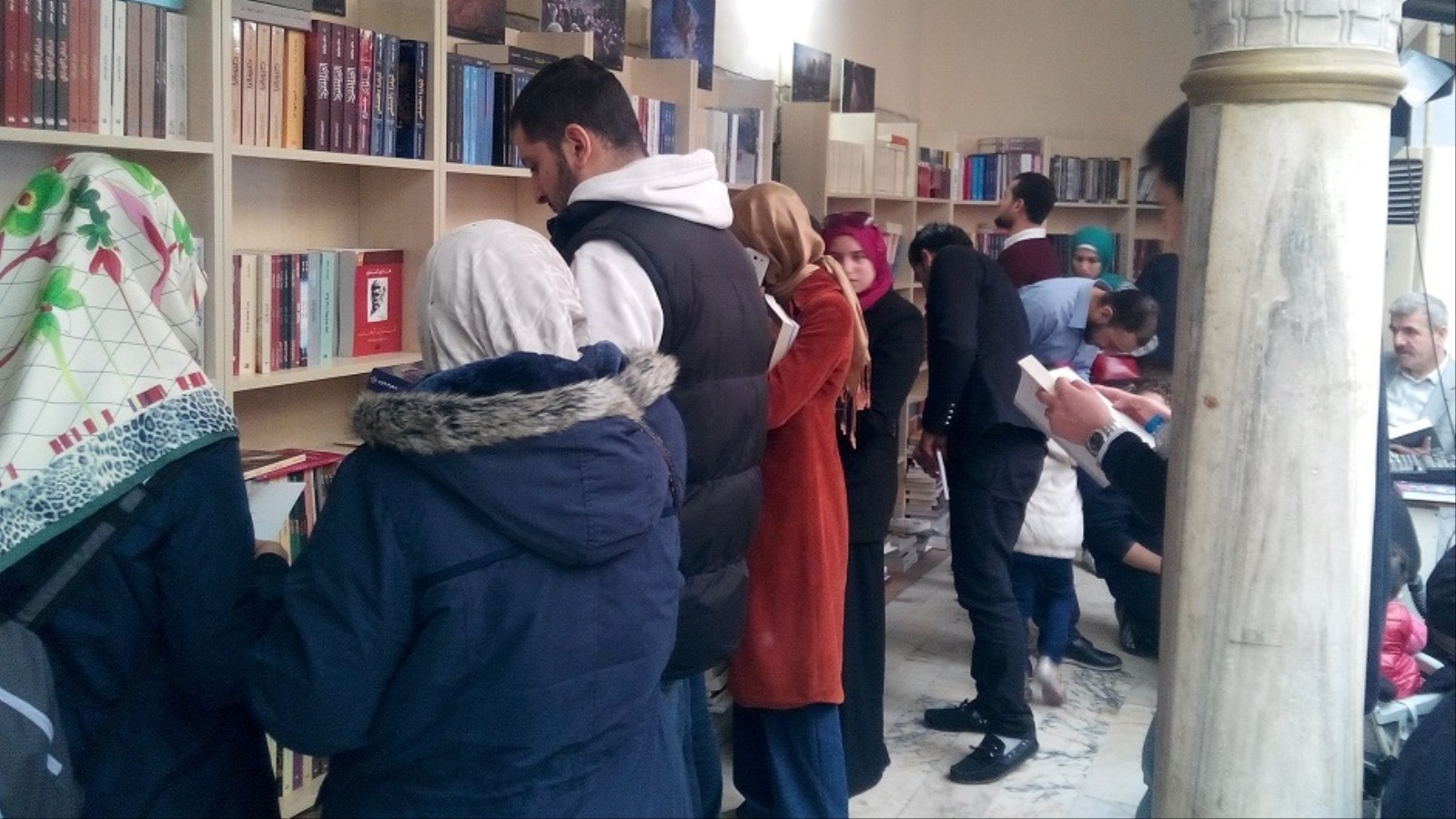 ‪زوار يطلعون على الكتب في رفوف معرض الكتاب العربي الأول بإسطنبول‬ (الجزيرة)