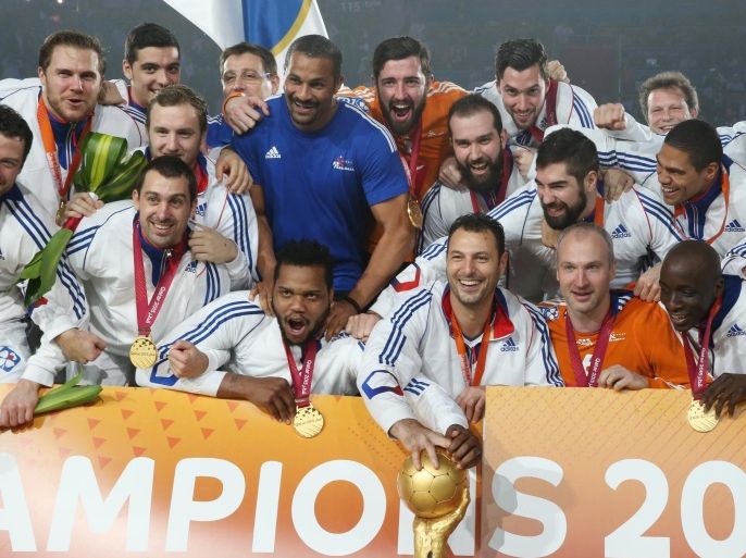 French team players celebrate with the trophy during the podium ceremony of 24th Men's Handball World Championships at the Lusail Multipurpose Hall in Doha, Qatar, Sunday, Feb. 1, 2015. (AP Photo/Osama Faisal)
