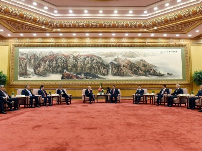Chinese President Xi Jinping, center right, speaks to Swiss Economy Minister Johann Schneider-Ammann as he meets with delegates attending the signing ceremony for the Articles of Agreement of the Asian Infrastructure Investment Bank (AIIB) at the Great Hall of the People in Beijing Monday, June 29, 2015. Envoys of governments that plan to join the Chinese-led Asian bank endorsed a structure Monday that gives Beijing the biggest voting stake at the start but no veto power. The Beijing-based bank is part of China's efforts to gain a bigger voice in global financial regulation that is dominated by the United States and Europe. (Wang Zhao/Pool Photo via AP)