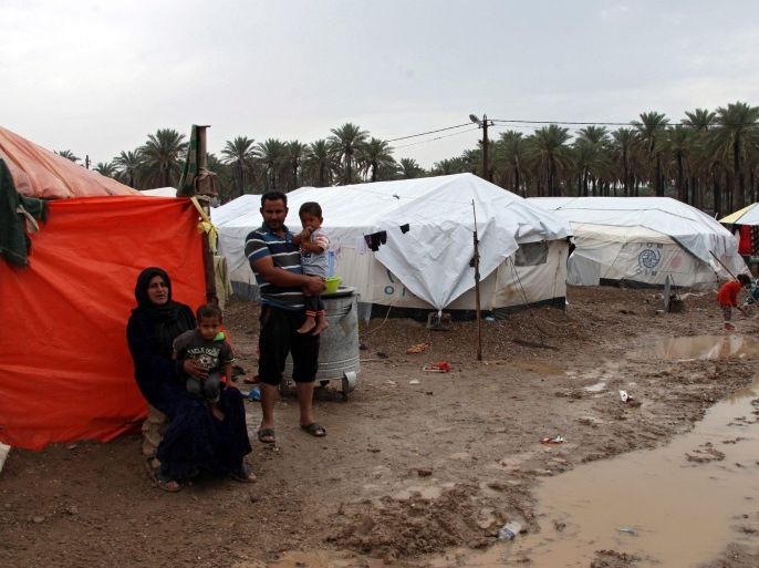 Iraqi displaced people, who were forced to flee their homes in Ramadi city western Iraq, ahead of gains made by Islamic State (IS) militants, sit next to their tent during a rainy day at a refugee camp in southern Baghdad, Iraq, 05 November 2015. Iraq is experiencing low temperatures and rain adding to the suffering IDPs in camps across Iraq. Government troops, backed by tribal paramilitaries and airstrikes carried out by the international anti-IS coalition, continue to battle for control of Ramadi, the capital of Anbar province, western Iraq. EPA/AHMED JALIL