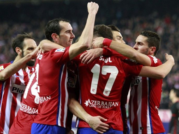 Atletico Madrid's midfielder Saul Niguez (C) celebrates with teammates after scoring the 1-1 equalizer against Athletic Club during their Spanish Liga Primera Division soccer match played at Vicente Calderon stadium, in Madrid, Spain, 13 December 2015.