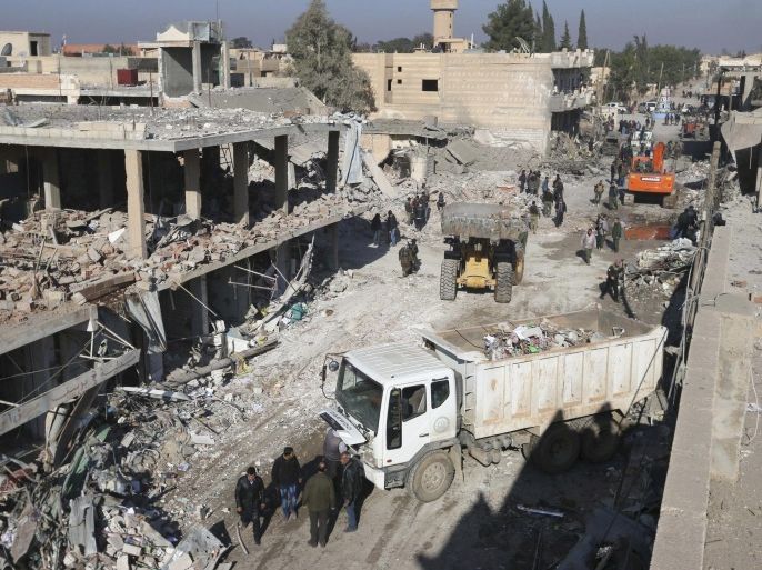 Residents inspect damage at a site hit by one of three explosive trucks, in the YPG-controlled town of Tel Tamer, Syria December 11, 2015. A spokesman for the Syrian Kurdish YPG militia said the death toll from a triple truck bomb attack in a town in northeastern Syria on Friday had risen to 50 to 60 people, with more than 80 others wounded. One of the blasts occurred outside a hospital, another at a market and the third in a residential area in the YPG-controlled town of Tel Tamer, Redur Xelil said via Internet messaging service. REUTERS/Rodi Said