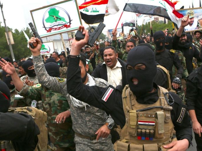Shiite militiamen and protesters shout slogans and brandish weapons during a demonstration calling again for the immediate withdrawal of Turkish troops from northern Iraq, in Basra, southern Iraq, Saturday, Dec. 12, 2015. An outpouring of public anger over the Turkish troops crisis that erupted earlier this month was on display at Saturday’s protests in Basra and the capital, Baghdad. Turkey has had troops near Mosul since last year but the arrival of additional troops last week sparked an uproar. (AP Photo/Nabil al-Jurani)