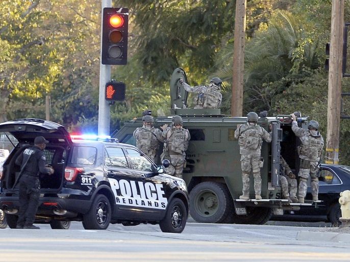 SWAT officers deploy near the scene where suspects in the shooting at the Inland Regional Center were reportedly apprehended, in San Bernardino, California, USA, 02 December 2015. Police were scouring a residential neighbourhood for a possible third suspect after trading gunfire with occupants of a vehicle linked to an earlier massacre in San Bernardino, police spokeswoman Vicki Cervantes said. A shooting at a government building west of Los Angeles left 'upwards of 14 people' dead and at least 14 wounded, San Bernardino Police Chief Jarrod Burguan says.