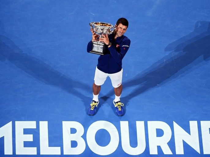 Novak Djokovic of Serbia holds his trophy after winning the Men's Final against Andy Murray of Britain at the Australian Open tennis tournament in Melbourne, Australia, 31 January 2016. EPA/JOE CASTRO AUSTRALIA AND NEW ZEALAND OUT