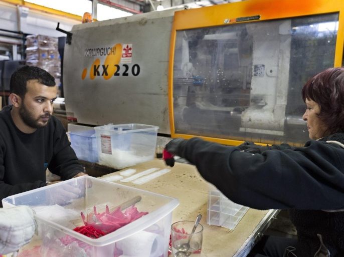 Nina (R), an Israeli who lives in the Jewish settlement of Ariel in the West Bank, works alongside Palestinian worker Basel, in the Twito Plast factory located in the Barkan Industrial Area, outside Ariel in the West Bank, 09 December 2015. Israel in November suspended several committee talks and forums with the European Union in retaliation for a decision to label products from Israeli settlements in the occupied territories. The European Union's executive said that agricultural and cosmetic goods produced in the settlements must be labelled as such rather than just as coming from Israel.