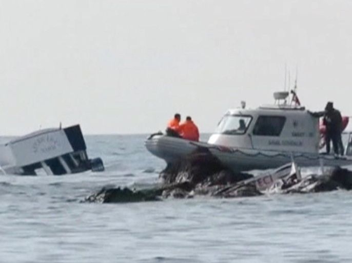 A boat (L) which carried migrants sinks into the sea off Turkey's western coast of Ayvacik, are seen in this still image from video taken January 30, 2016. Almost 40 people drowned and 75 were rescued after a boat carrying migrants to Greece sank off Turkey's western coast on Saturday, according to local officials and the Turkish Dogan news agency. The Turkish coast guard was continuing search and rescue efforts where the 17-metre boat carrying at least 120 people sank off the coast of Ayvacik, a town across from the Greek island of Lesvos, the Dogan news agency reported. REUTERS/Reuters TV